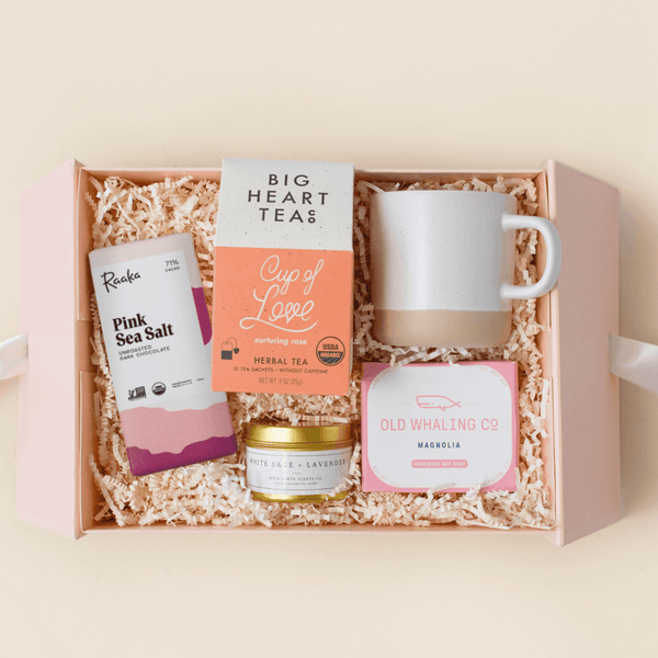 Magnolia floral self-care gift box with rose tea, sea salt candle, magnolia soap, and chocolate in a pink Unboxme gift box