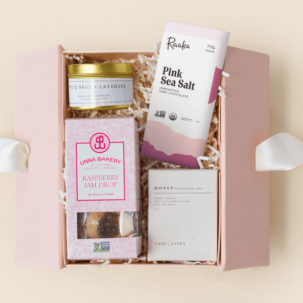 Petite Sweets treat gift box with sea salt chocolate, raspberry cookies, and cleansing bar in a pink Unboxme gift box