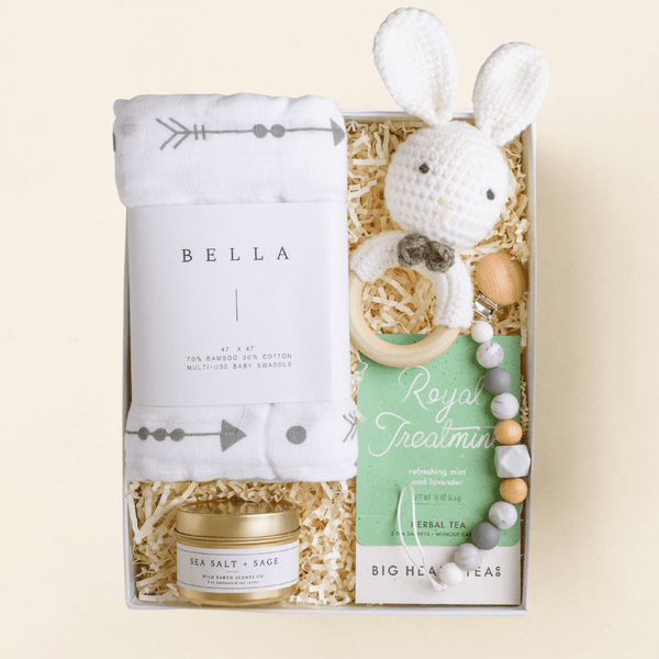 Welcome Little One newborn gift box with swaddle, crochet bunny, candle, and tea in a blue Unboxme gift box