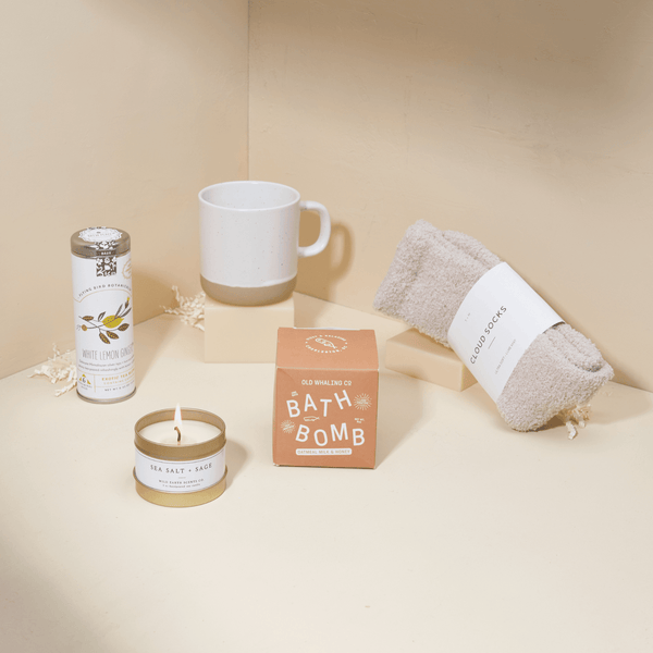 Heal get well care package with ginger tea, ceramic mug, sage candle, and bath essentials in a blue Unboxme gift box