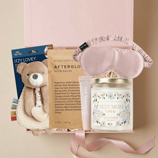 New Mom gift box with bath salts, candle, sleep mask, lip treatment, and baby plush in a pink Unboxme gift box