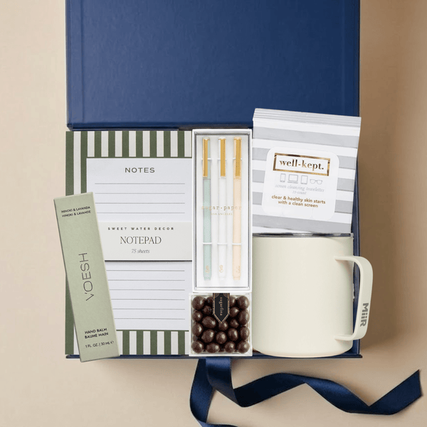 Office Hours work from home gift box with notepad, pen set, screen wipes, hand balm, camp mug, and chocolate in a blue Unboxme gift box