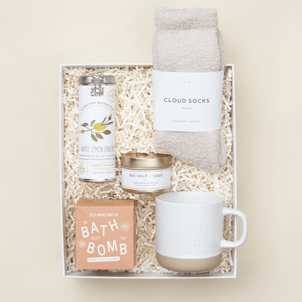 Heal get well care package with ginger tea, ceramic mug, sage candle, and bath essentials in a blue Unboxme gift box