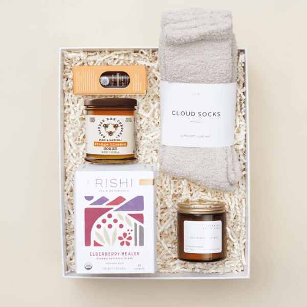 Get well soon gift box with honey, herbal tea, cozy socks, and essential oils in a blue Unboxme gift box
