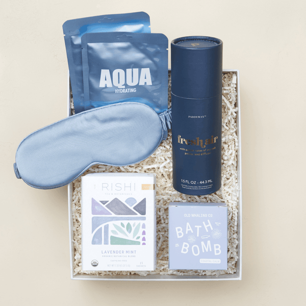 Zen relaxation gift box with candle, herbal tea, silk eye mask, and self-care essentials in a white Unboxme gift box