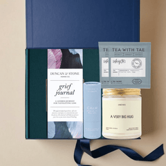 With Deepest Sympathy gift box with grief journal, calming tea, essential oil blend, and candle in a blue Unboxme gift box